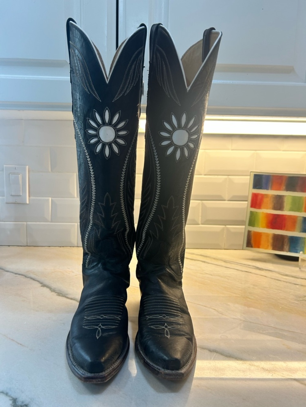 Lucchese, black with white detail floral/sunburst inlay. Size 8. Lightly worn